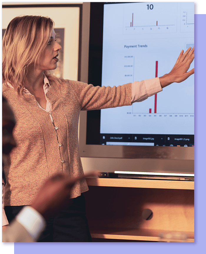Woman gesturing to presentation screen