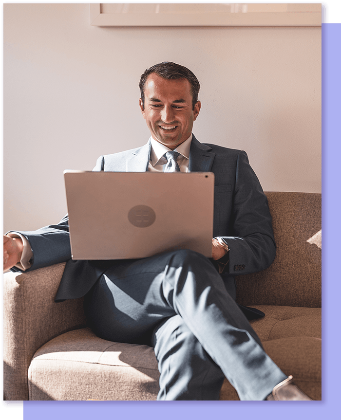 Man smiling working on laptop